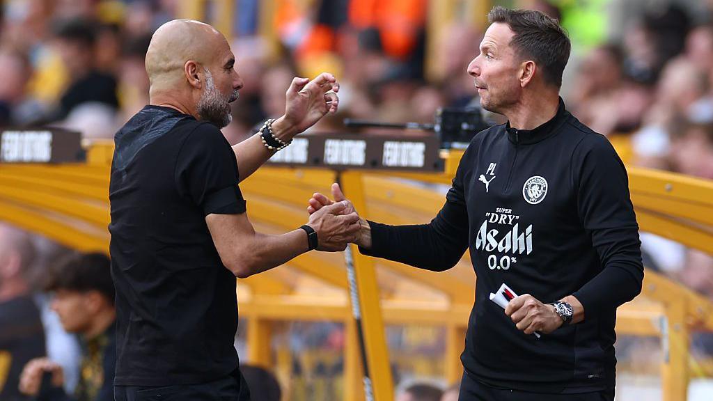 Pep Guardiola shakes hands with Pep Lijnders