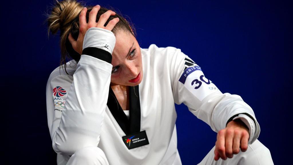 Jade Jones sat holding head in disappointment