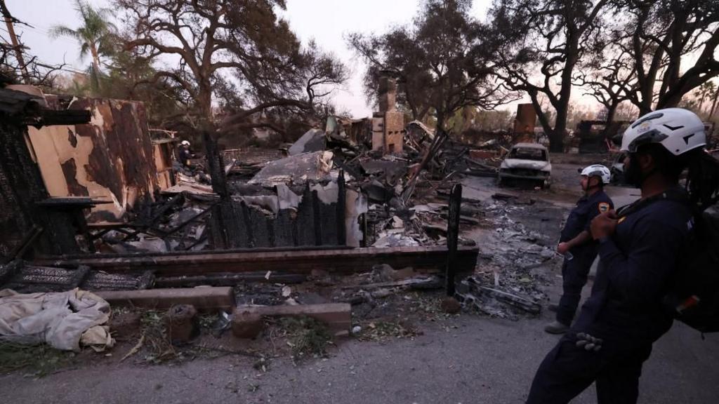 Marin County Search and Rescue team inspects a burned property for hazards and remains during the Eaton fire in Altadena, California, U.S., January 11, 2025