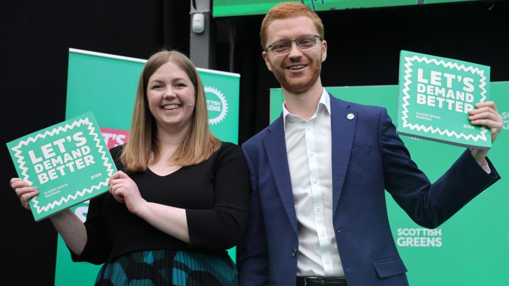 Co-leaders Gillian Mackay and Ross Greer hold the party manifesto at the Scottish Greens launch 