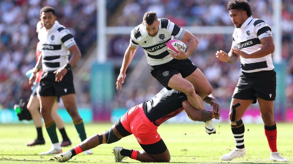 Jonny May is tackled playing for the Barbarians