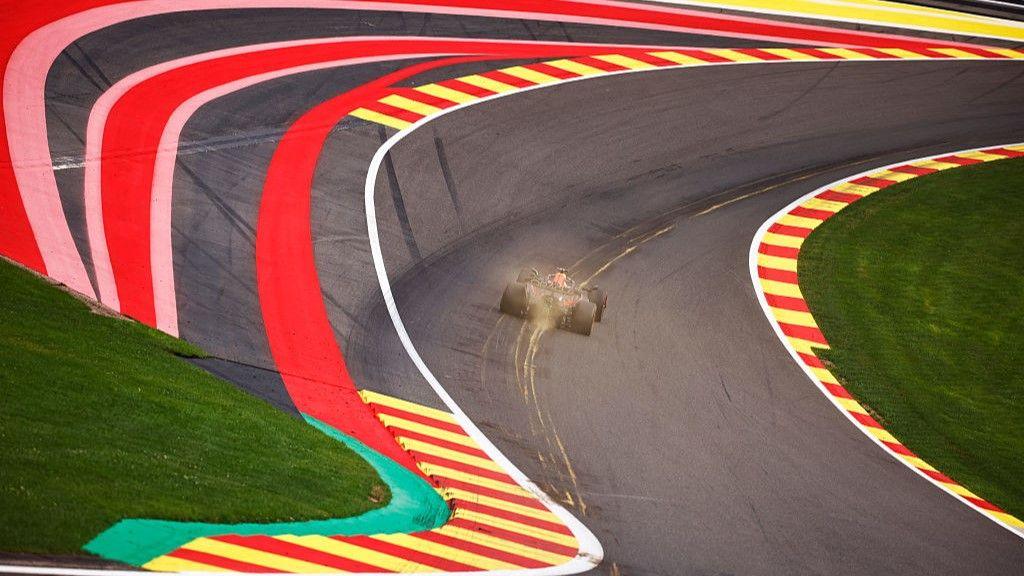 An F1 car speeds through Eau Rouge at Spa