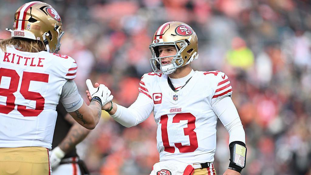 San Francisco 49ers quarterback Brock Purdy shakes hands with team-mate, tight end George Kittle during their team's win at the Cleveland Browns in the NFL