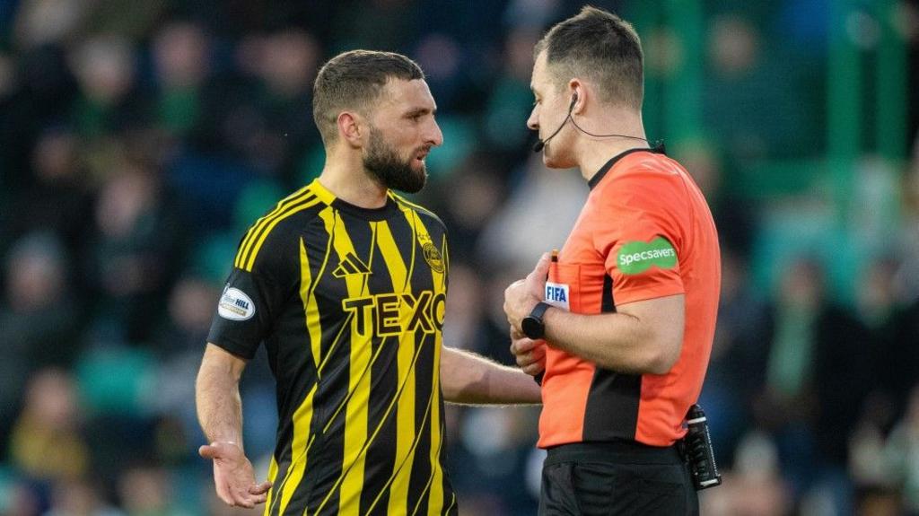 Aberdeen captain Graeme Shinnie with referee Don Robertson