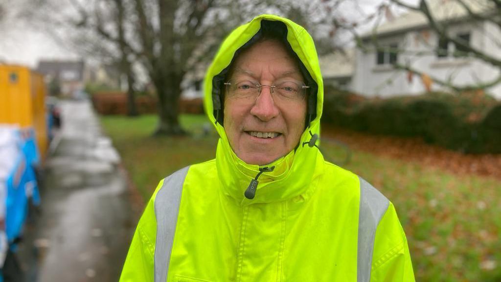 Flood warden Andy Leeder standing outside in a high-vis jacket