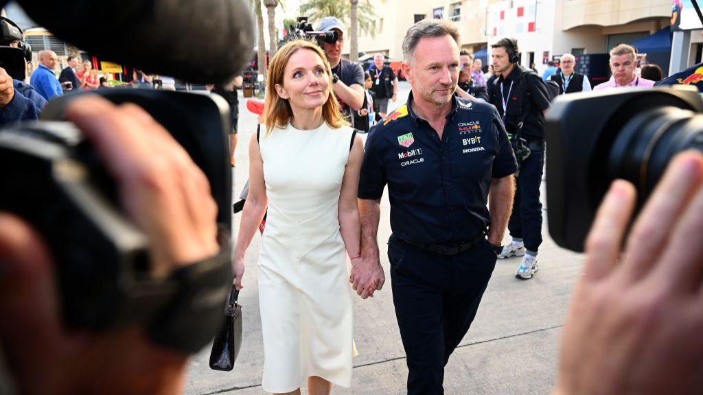 Geri Halliwell-Horner and husband Christian Horner walk hand in hand prior to the 2024 F1 Grand Prix of Bahrain