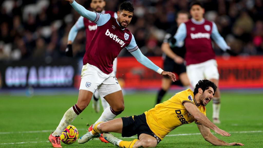 Goncalo Guedes of Wolverhampton Wanderers is challenged by Emerson Palmieri of West Ham United leading to a VAR penalty review which results in no penalty to Wolverhampton Wanderers