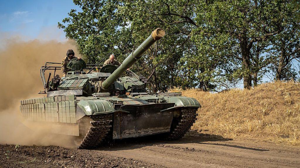 Dust rises as a Ukrainian soldier drives a tank down a dirt road in Kherson, Ukraine on 8 August.