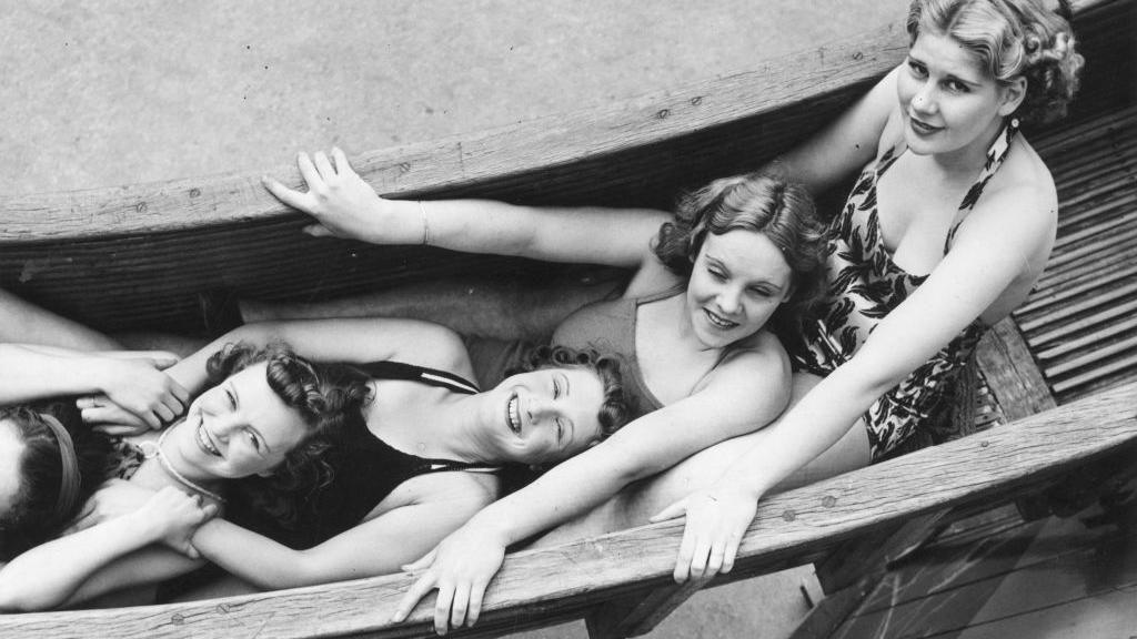 Women in their swimsuits and vintage hairstyles on the helter-skelter ride at Coney Beach Amusement Park in Porthcawl, Wales in August 1939