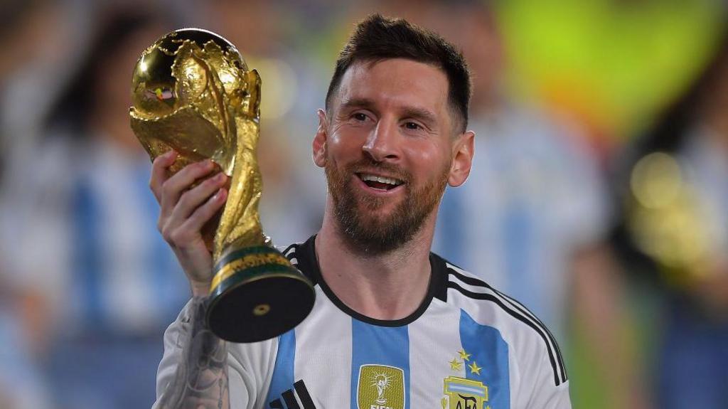 Lionel Messi holding the World Cup trophy