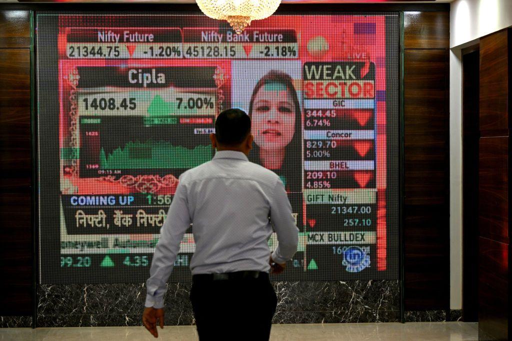 A man walks past a digital display inside the Bombay Stock Exchange (BSE) building in Mumbai on January 23, 2024. India's stock market has edged out Hong Kong to become the world's fourth-largest, a milestone that underscores growing global investor optimism about New Delhi's economic prospects, Bloomberg said on January 23. (P