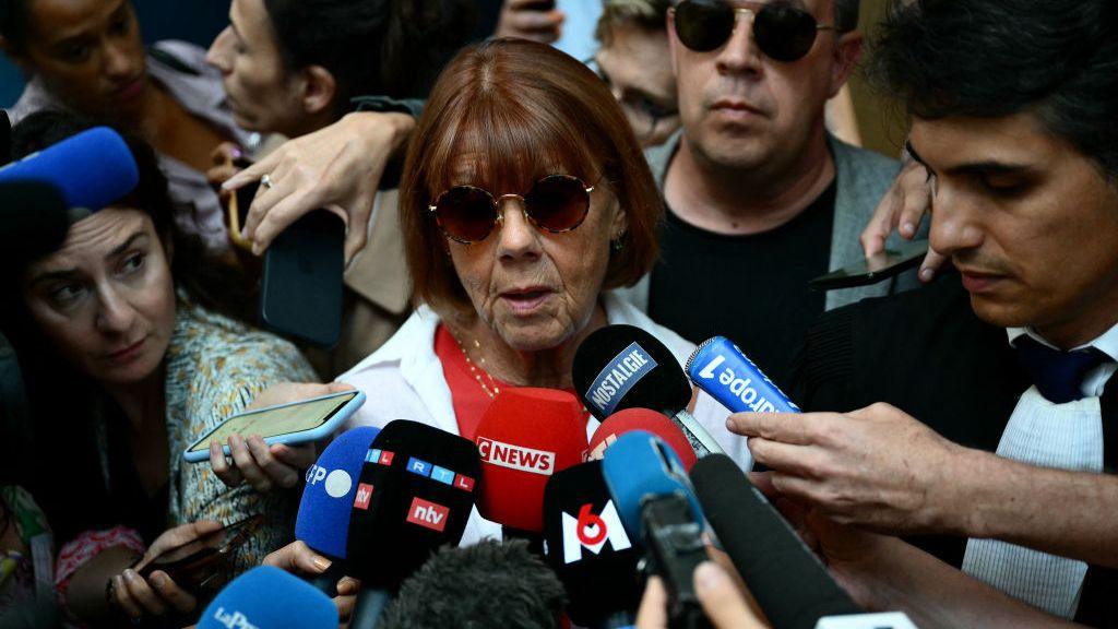 Gisèle Pélicot outside court surrounded by reporters