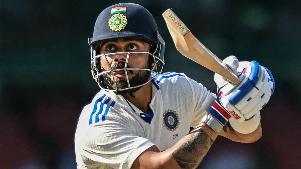 India's Virat Kohli watches the ball after playing a shot during the fourth day of the second Test cricket match between India and Bangladesh at the Green Park Stadium in Kanpur on September 30, 2024