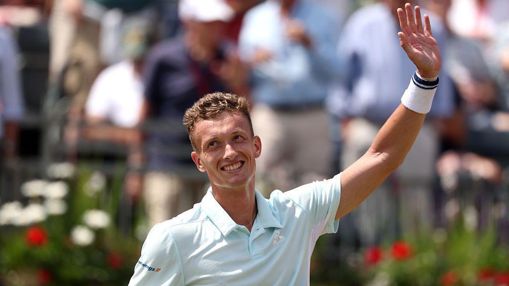 Jiri Lehecka waves to the crowd at Queen's
