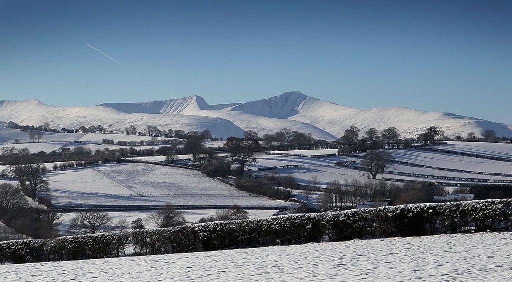 Snow covered scene of hills in Wales, including Pen-y-fan - the highest peak in south Wales - in the distance