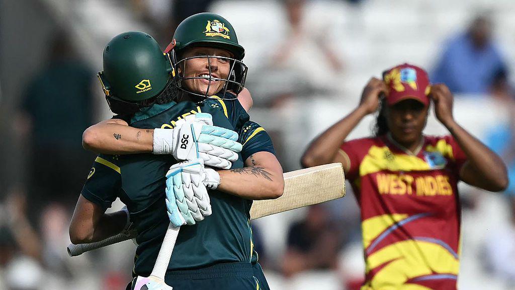 Australia's Beth Mooney and Ashleigh Gardner celebrate their team's victory against West Indies.