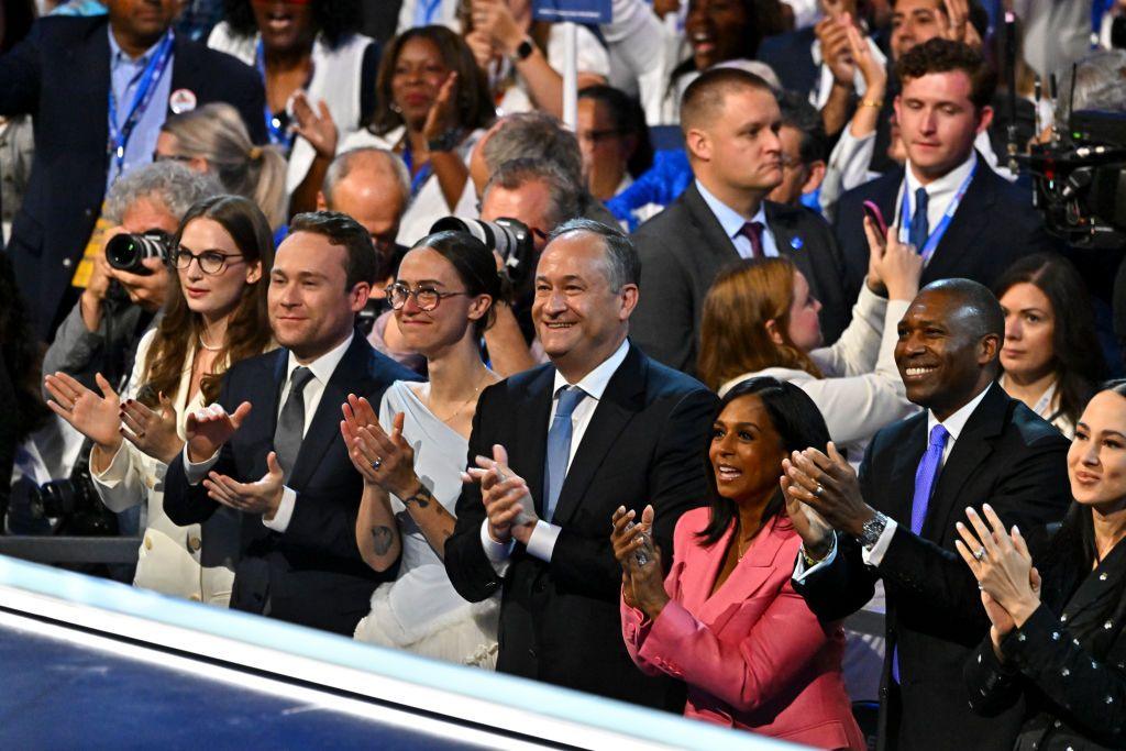 Greenley Littlejohn, Cole Emhoff, Ella Emhoff, second gentleman Douglas Emhoff, Maya Harris and Tony West watch Vice President Kamala Harris on stage at the Democratic National Convention in Chicago.