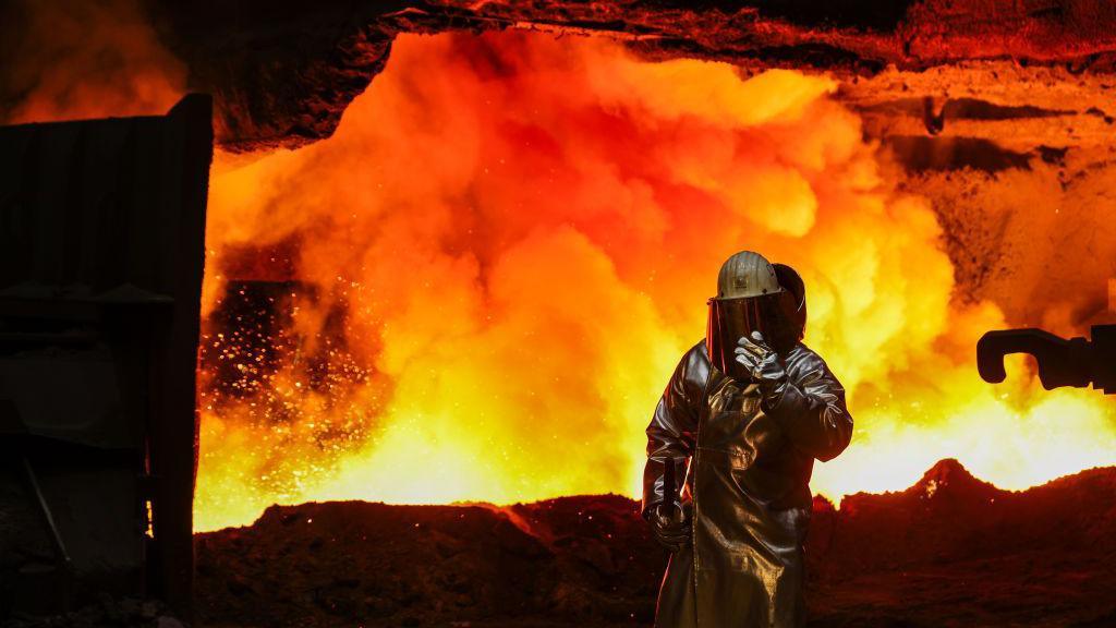 A worker beside a blast furnace at the Thyssenkrupp Steel Europe AG steel plant in Duisburg, Germany