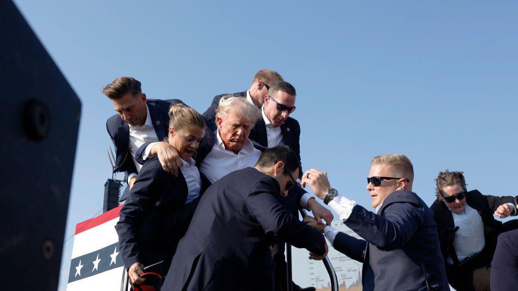 Trump being taken off stage by Secret Service officers in Butler, Pennsylvania on 13 July