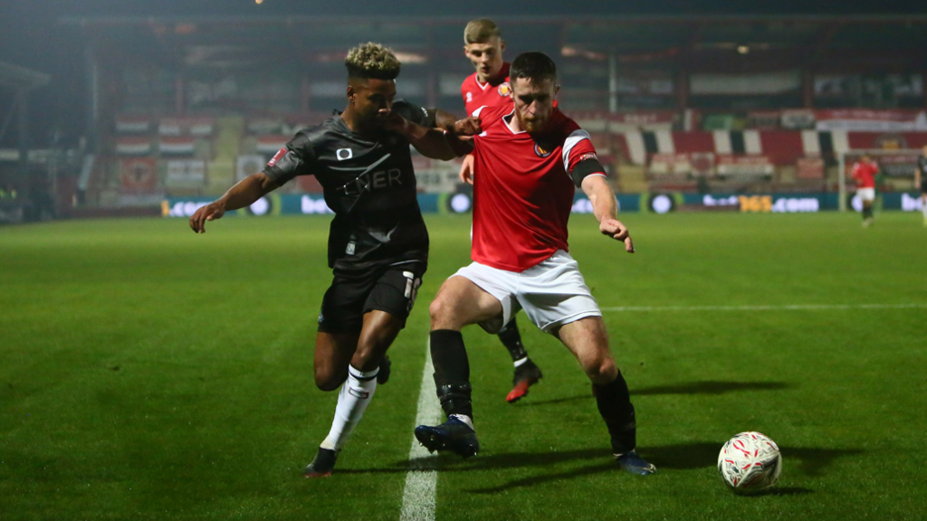 FC United of Manchester's Adam Dodd (right) in action against Doncaster Rovers in an FA Cup tie in November 2020