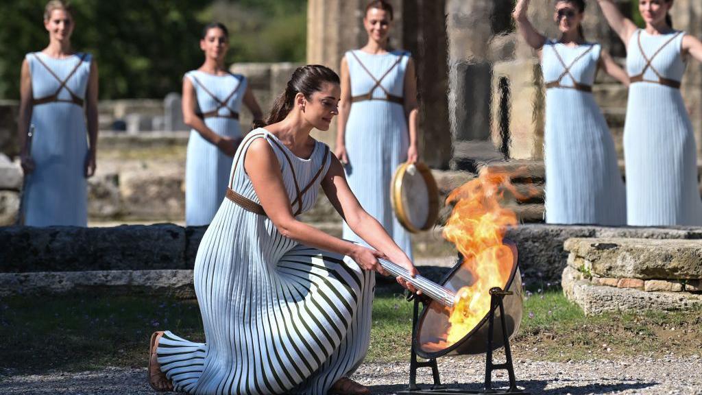 Olympic torch lighting ceremony taking place outside in 2021.
