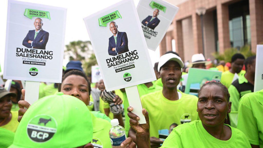 Supporters of the BCP wear lime green T-shirts and wave placards with the portrait of leader Dumelang Saleshando.