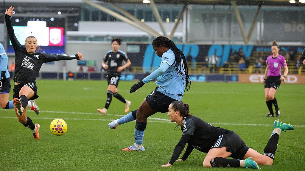 Khadija Shaw scoring a goal.