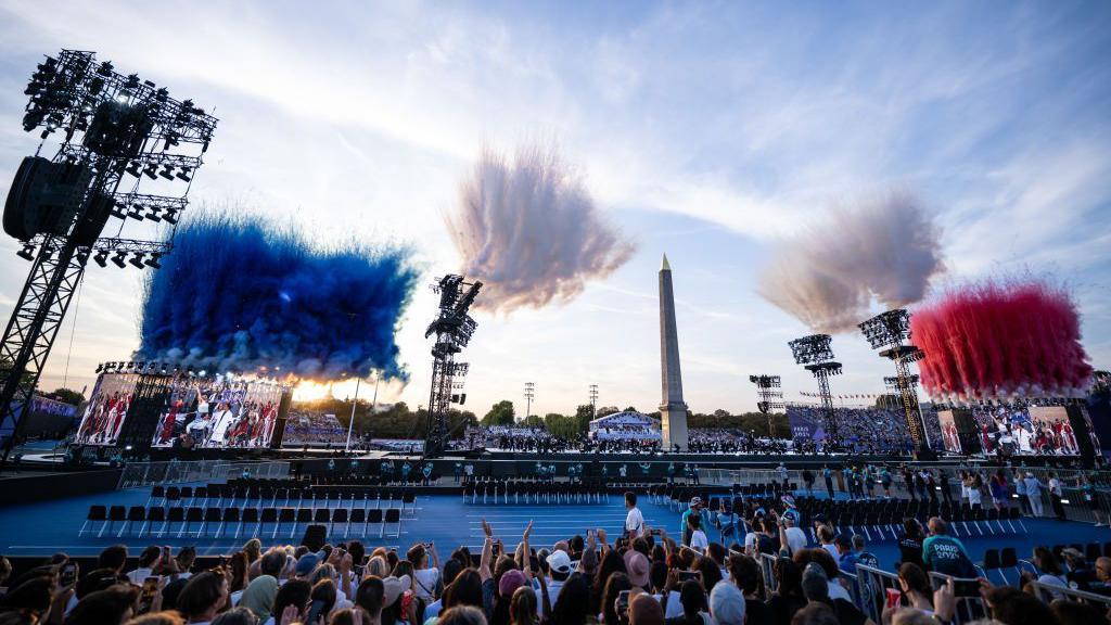 A general view as smoke is released in the colours of the French flag whilst dancers perform during the opening ceremony of the Paris 2024 Summer Paralympic Games