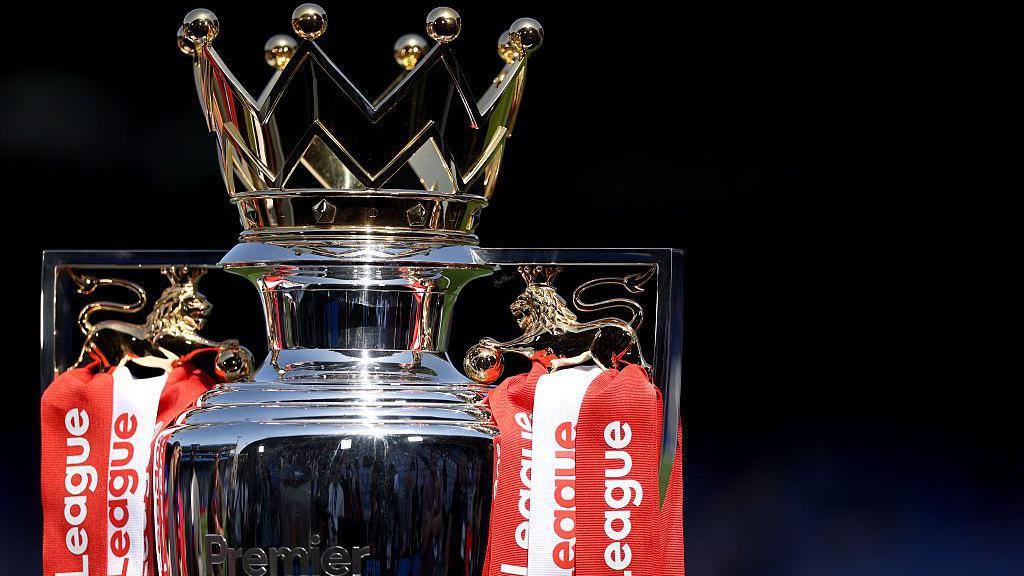The Premier League trophy, adorned with red and white ribbons for champions Arsenal, sits pitchside at Selhurst Park beforer the end of season presentation and celebrations