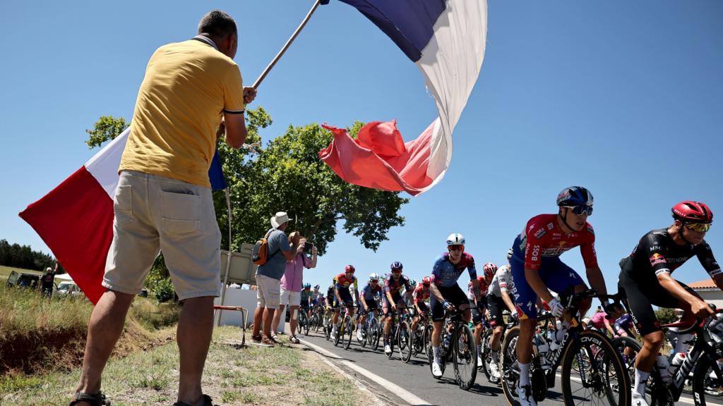 A cycling fan wears a French flag during stage 16 of the 2025 Tour de France