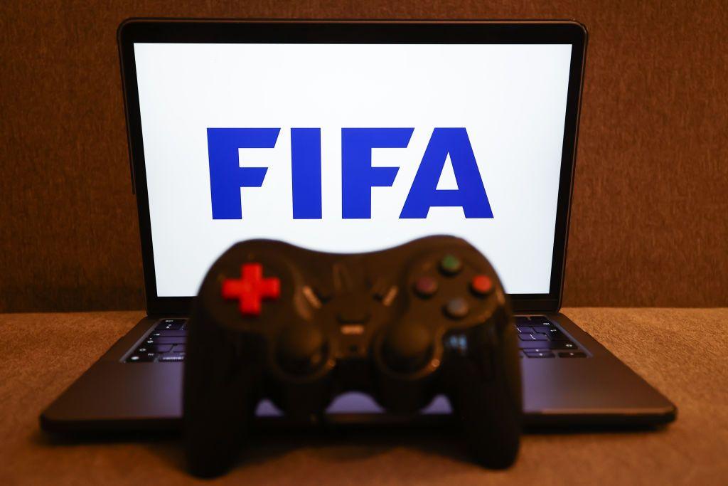 FIFA logo displayed on a laptop screen and a gamepad.