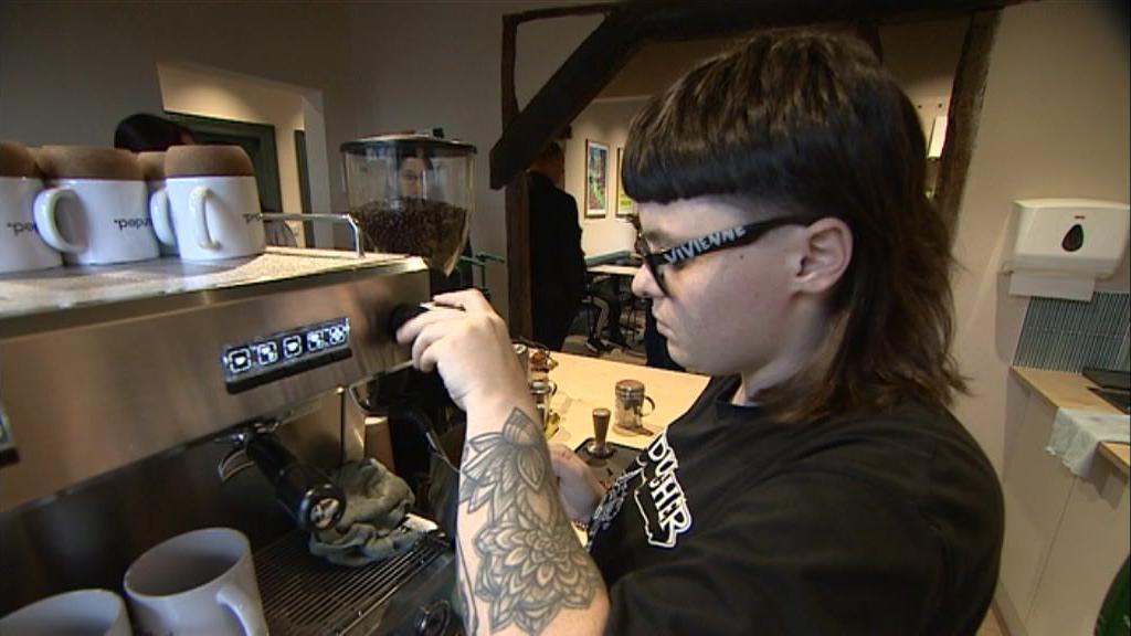 A barista at Grounded cafe prepares a hot drink