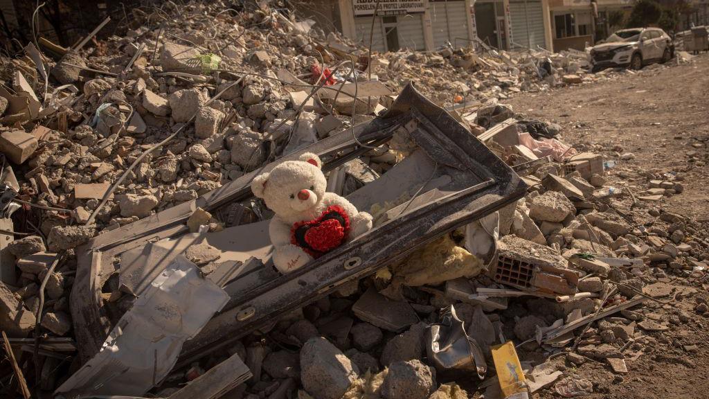 A teddy bear is seen amid rubble from a destroyed building on February 13, 2023 in Nurdagi, Turkey