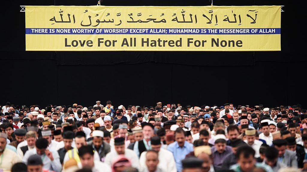 Members of the Ahmadiyya Muslim community are led in prayer