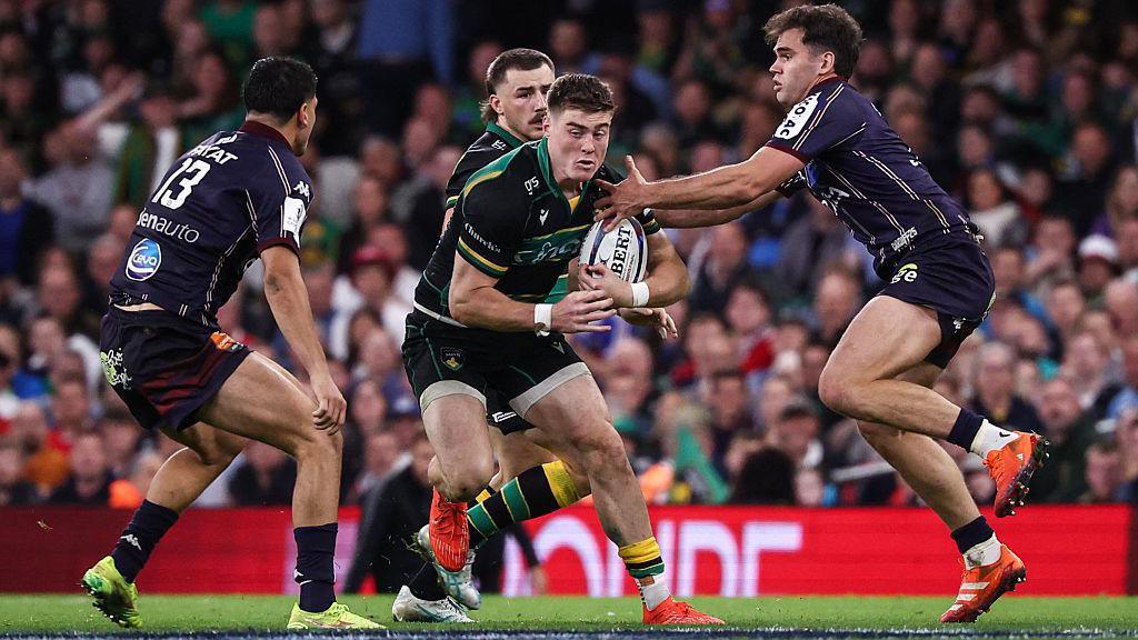 Tommy Freeman, ball in hand, is approached by two opponents from Union Bordeaux Begles during Northampton's defeat in the Champions Cup.