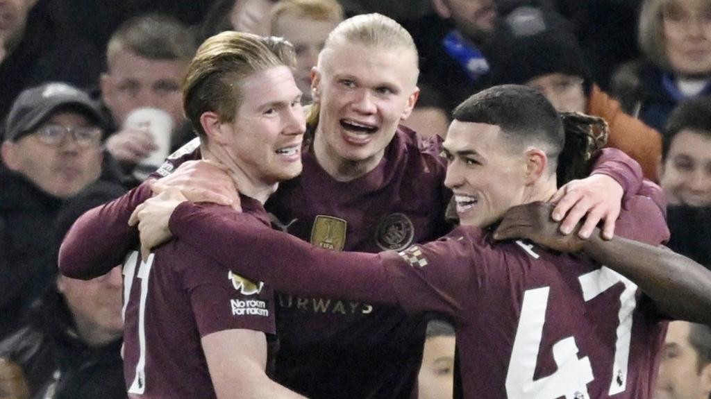 Manchester City's players celebrate as they score against Ipswich