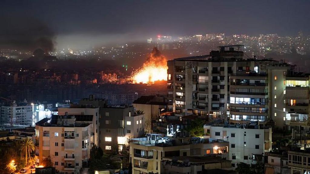 Smoke rises over Beirut's southern suburb of Dahieh following Israeli airstrikes after Hezbollah launched a barrage of rockets and announced a new phase of the war on March 11