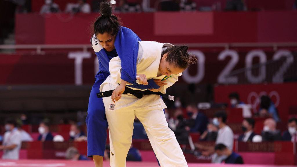 Brazil's Maria Portela (white) and Refugee Olympic Team's Nigara Shaheen compete in the judo women's -70kg elimination round bout during the Tokyo 2020 Olympic Games at the Nippon Budokan in Tokyo on July 28, 2021. 