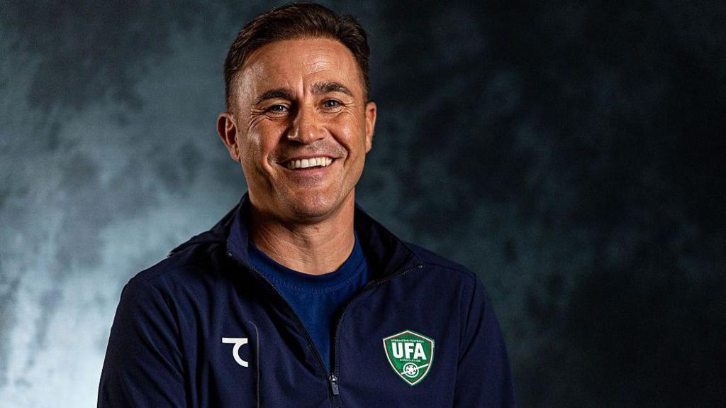 A smiling Fabio Cannavaro in an Uzbekistan tracksuit
