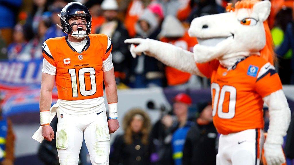 Mascot of the Denver Broncos pointing at Bo Nix