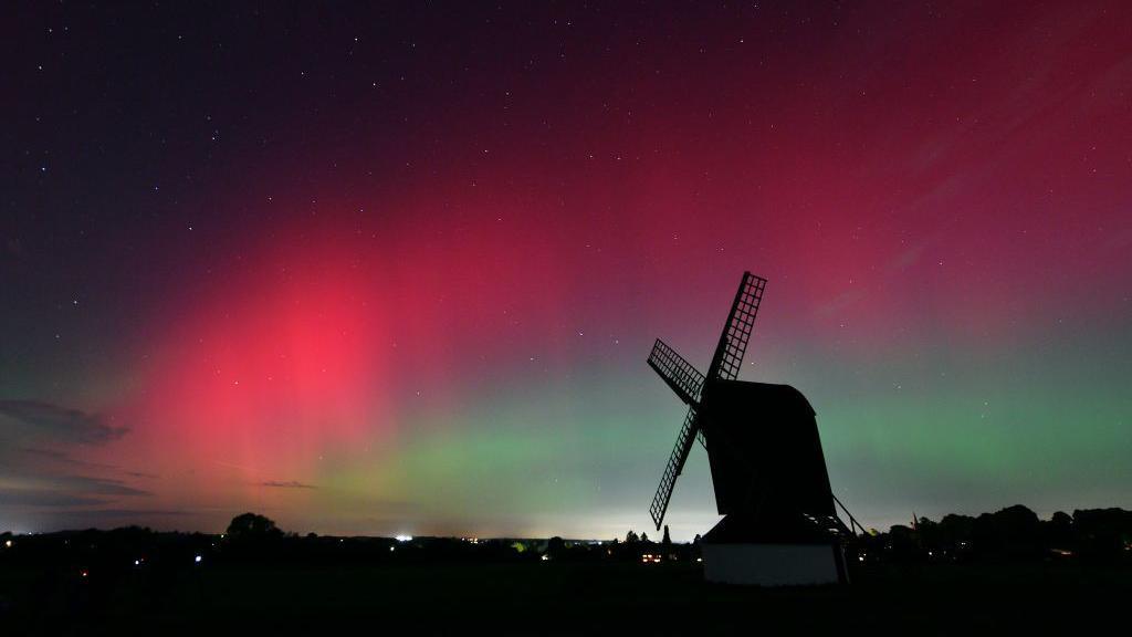 PITSTONE, UNITED KINGDOM - OCTOBER 10: The Aurora Borealis lights up the night sky over Pitstone Windmill in Buckinghamshire on October 10, 2024 in Pitstone, United Kingdom. The Aurora Borealis or "Northern Lights" results from geomagnetic storms and can be seen as far south as the UK overnight on the 10th October. (Photo by Jim Dyson/Getty Images)