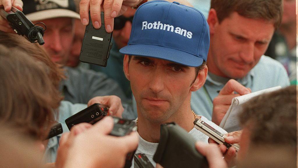 Damon Hill is surrounded by journalists after losing the F1 title to Michael Schumacher in 1994