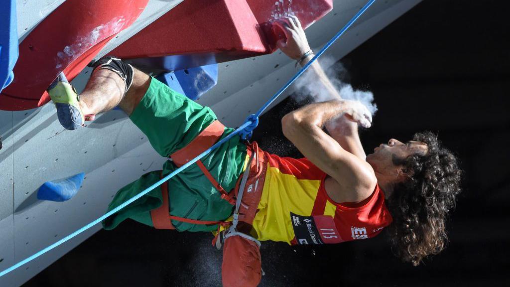 A para-athlete scales a climbing wall