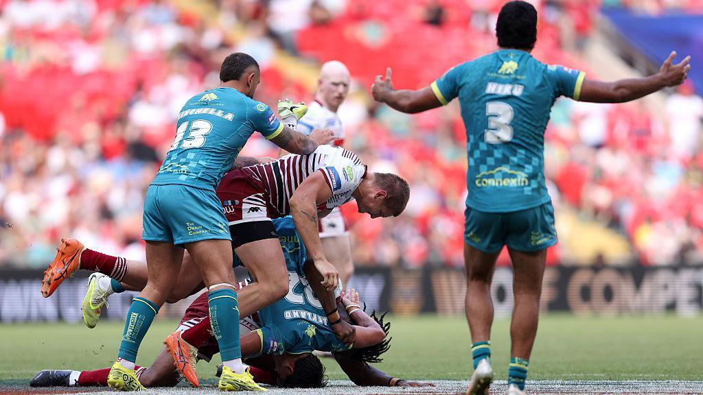 Sam Walters with a dangerous tackle on Bill Leyland