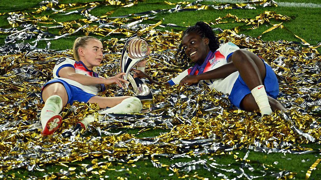 Chloe Kelly and Michelle Agyemang with the trophy