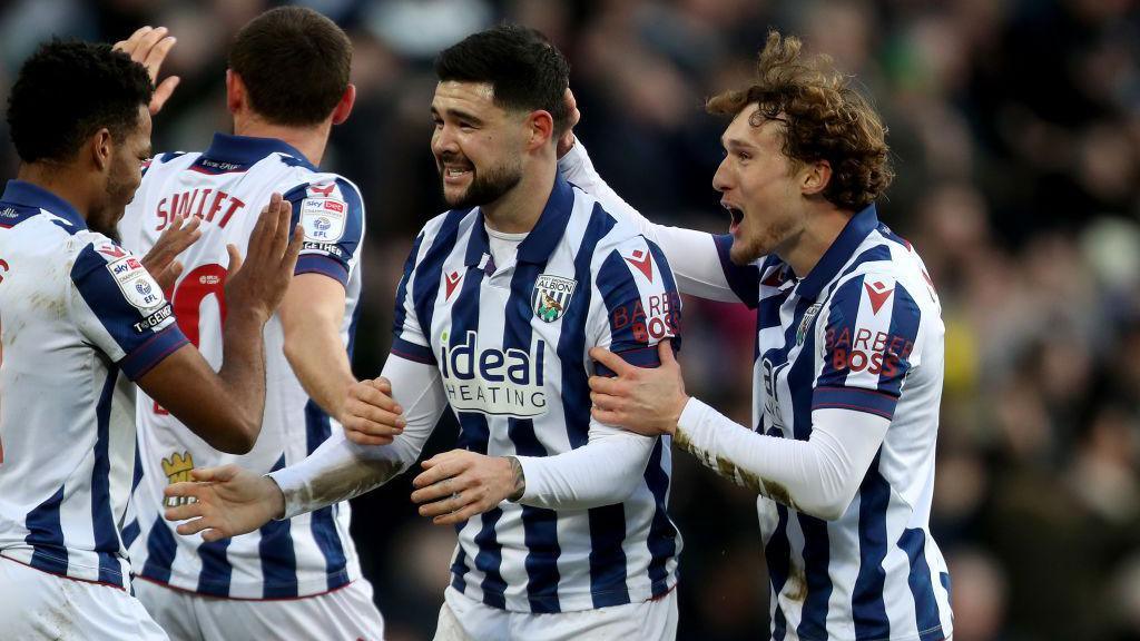 Alex Mowatt of West Bromwich Albion celebrates after scoring a goal to make it 1-0 with John Swift and Callum Styles