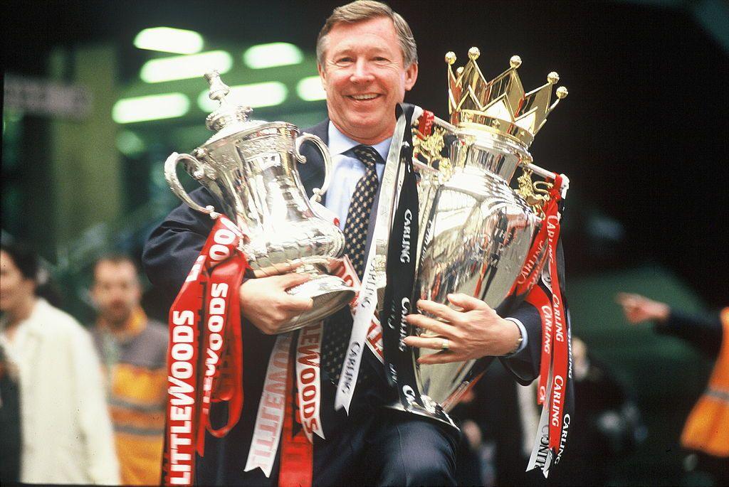 Sir Alex Ferguson with the FA Cup and Premiership Trophy at Victoria Station, Manchester, on 12 May, 1996 after completing The Double