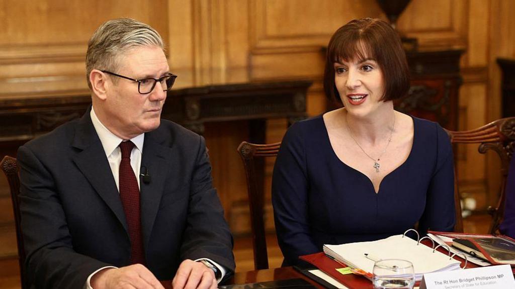 Britain's Education Secretary Bridget Phillipson (R) speaks as Britain's Prime Minister Keir Starmer (L) looks on.