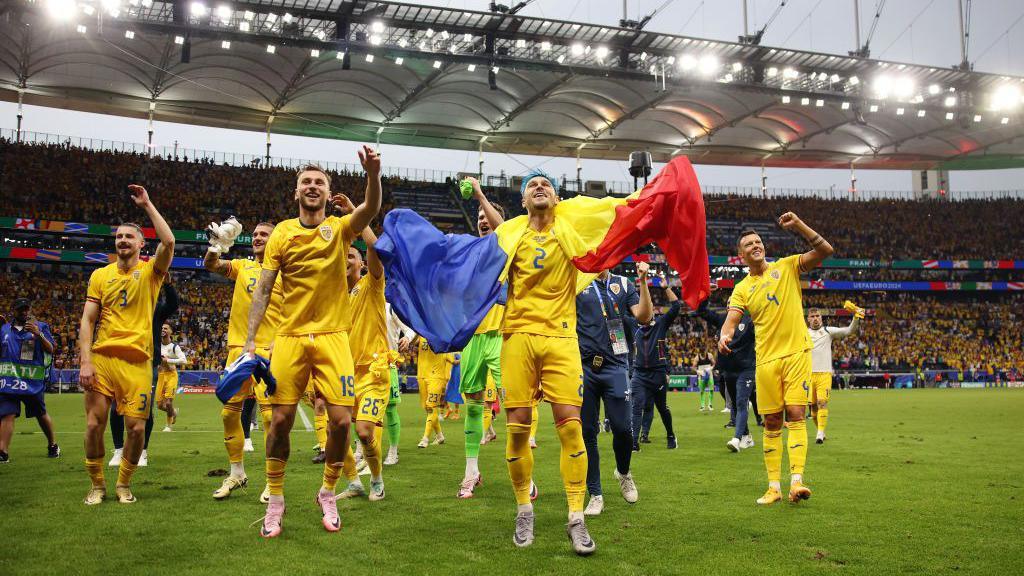 Romania celebrate qualifying for the knockouts