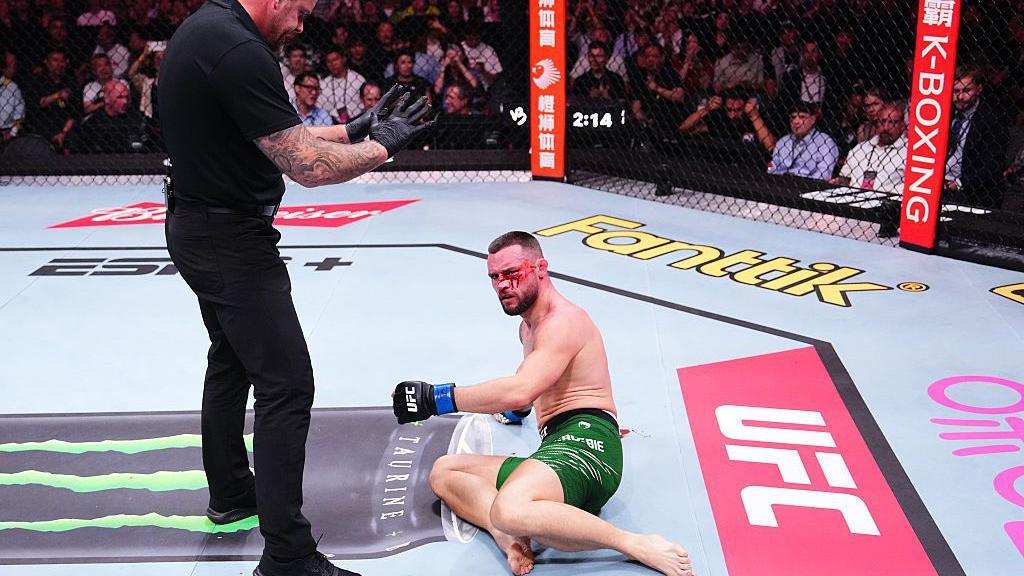 Kiefer Crosbie is bloodied as he lays on the canvas
